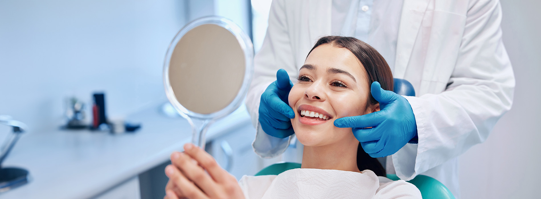 Professional dental hygienist performing a teeth cleaning procedure on a patient in a dental office.