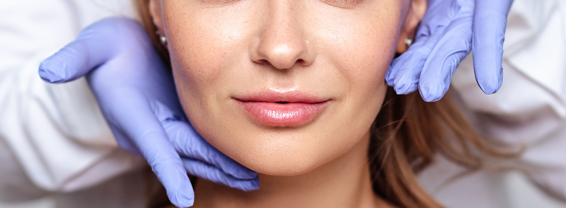 The image shows a person receiving a facial treatment, with a visible medical professional s hand holding a facial mask over the individual s face.